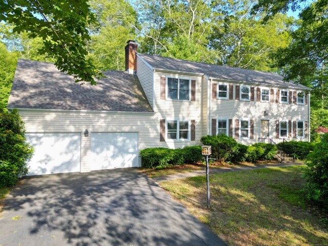 22 Trumbull Rd, Waterford, CT 06385 - colonial-style house featuring an attached garage, driveway, and a chimney