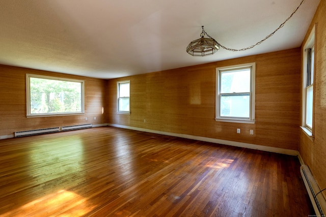 22 Trumbull Rd, Waterford, CT 06385 - empty room with a baseboard heating unit and wood finished floors