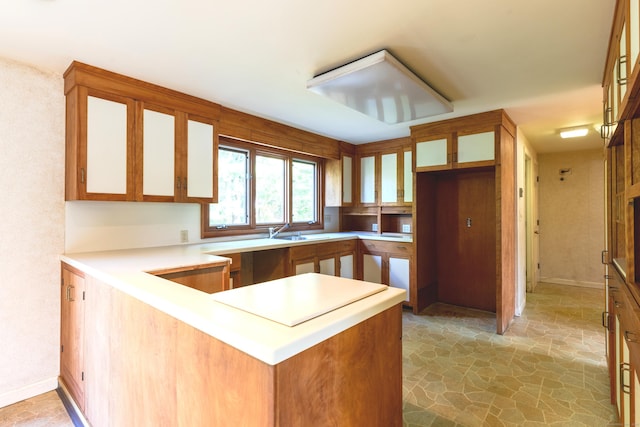 22 Trumbull Rd, Waterford, CT 06385 - kitchen with stone floors, a peninsula, glass insert cabinets, and light countertops