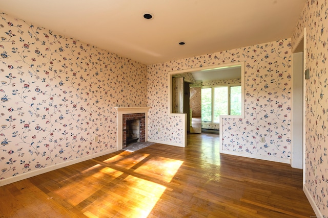 22 Trumbull Rd, Waterford, CT 06385 - unfurnished living room featuring wallpapered walls, wood finished floors, and a brick fireplace