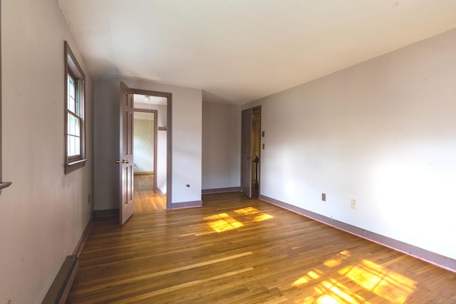 22 Trumbull Rd, Waterford, CT 06385 - empty room with wood finished floors and a baseboard radiator