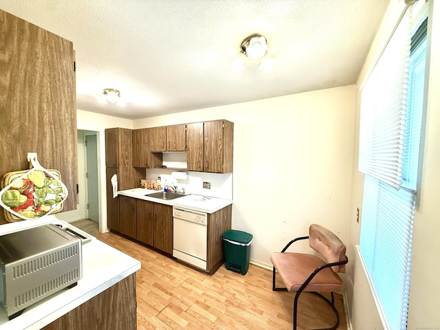 32 Heritage Vlg Unit C, Southbury, CT 06488 - kitchen featuring dishwasher, light countertops, light wood finished floors, a textured ceiling, and heating unit