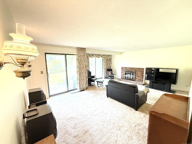 32 Heritage Vlg Unit C, Southbury, CT 06488 - carpeted living room with a textured ceiling and a fireplace