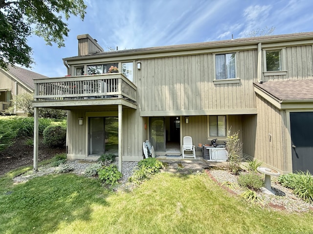 32 Heritage Vlg Unit C, Southbury, CT 06488 - rear view of house featuring a chimney, a yard, a wooden deck, and a patio area