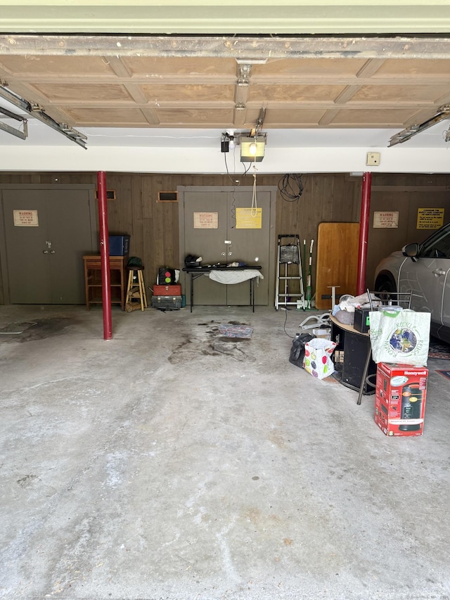 32 Heritage Vlg Unit C, Southbury, CT 06488 - garage with a garage door opener and wood walls