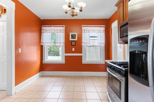 29 Bristol St, West Haven, CT 06516 - kitchen with stainless steel appliances, a chandelier, brown cabinets, and light tile patterned floors