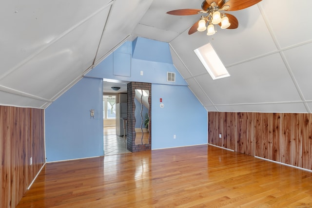 29 Bristol St, West Haven, CT 06516 - additional living space with wooden walls, a skylight, vaulted ceiling, wood finished floors, and ceiling fan