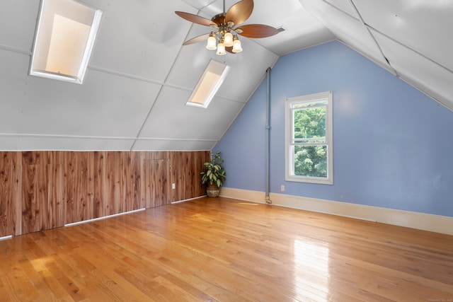 29 Bristol St, West Haven, CT 06516 - additional living space featuring light wood-style flooring, lofted ceiling, a ceiling fan, a skylight, and wood walls