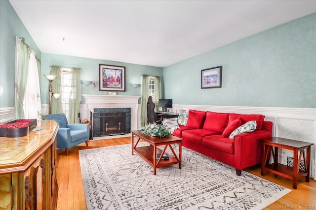 156 Killian Ave, Trumbull, CT 06611 - living area featuring wood finished floors, a wainscoted wall, and a premium fireplace