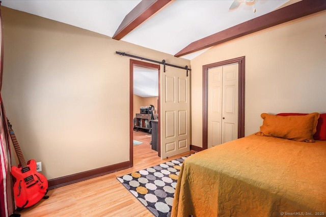 156 Killian Ave, Trumbull, CT 06611 - bedroom with a barn door, light wood finished floors, a closet, and a ceiling fan