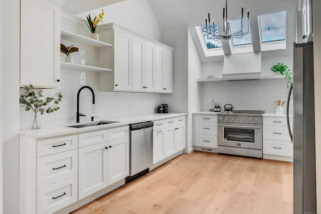 916 N Farms Rd, Wallingford, CT 06492 - kitchen with open shelves, stainless steel appliances, a skylight, tasteful backsplash, and vaulted ceiling