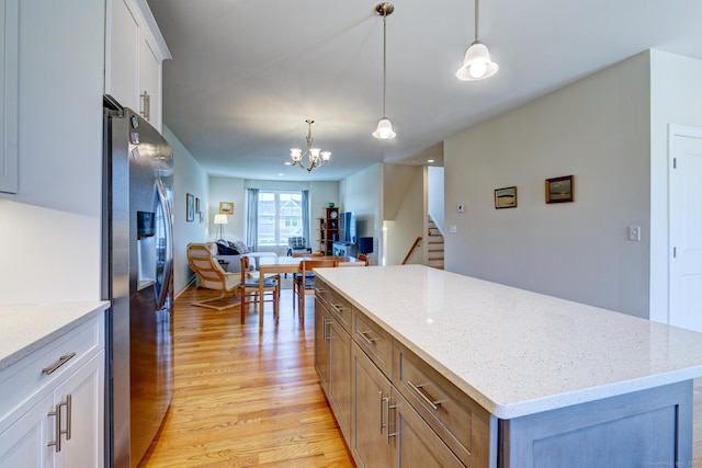 48 Park Ave Unit 48, Stonington, CT 06355 - kitchen with stainless steel refrigerator with ice dispenser, light wood-style floors, open floor plan, a kitchen island, and white cabinets