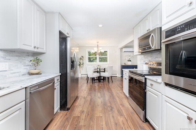 33 Terrace Rd, West Hartford, CT 06107 - kitchen with stainless steel appliances, a chandelier, white cabinets, recessed lighting, and backsplash