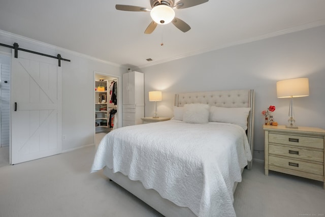 195 Southport Woods Dr Unit 195, Fairfield, CT 06890 - bedroom with light colored carpet, ornamental molding, a barn door, a spacious closet, and a closet
