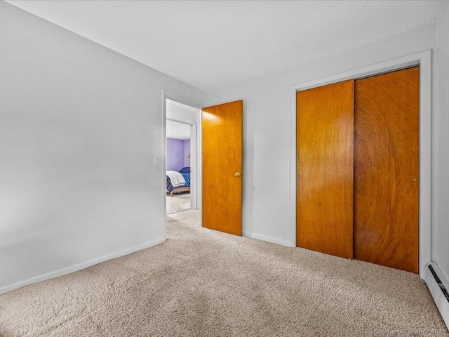 55 Oxbow Dr, Meriden, CT 06450 - unfurnished bedroom featuring carpet, a baseboard heating unit, and a closet