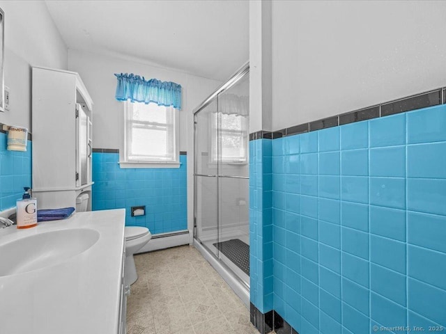 55 Oxbow Dr, Meriden, CT 06450 - bathroom featuring tile walls, a shower stall, a wainscoted wall, vanity, and a baseboard heating unit