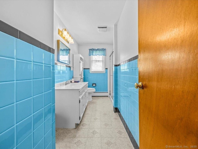 55 Oxbow Dr, Meriden, CT 06450 - bathroom featuring tile walls, vanity, a stall shower, wainscoting, and tile patterned floors