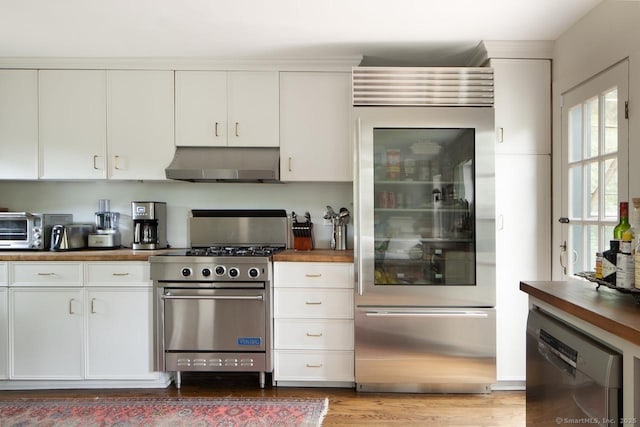 163 Dublin Rd, Canaan, CT 06031 - kitchen featuring appliances with stainless steel finishes, range hood, butcher block counters, white cabinetry, and light wood-style flooring