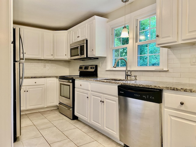 80 Murlyn Rd, Hamden, CT 06518 - kitchen featuring stainless steel appliances, white cabinetry, backsplash, light stone counters, and pendant lighting