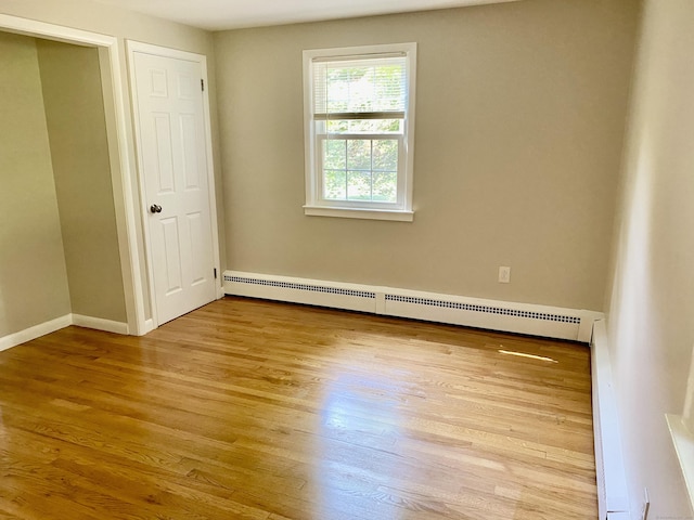 80 Murlyn Rd, Hamden, CT 06518 - unfurnished bedroom featuring a baseboard radiator and wood finished floors