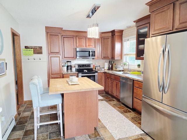 23 Teach St, Enfield, CT 06082 - kitchen with stainless steel appliances, a baseboard radiator, butcher block countertops, backsplash, and a kitchen island