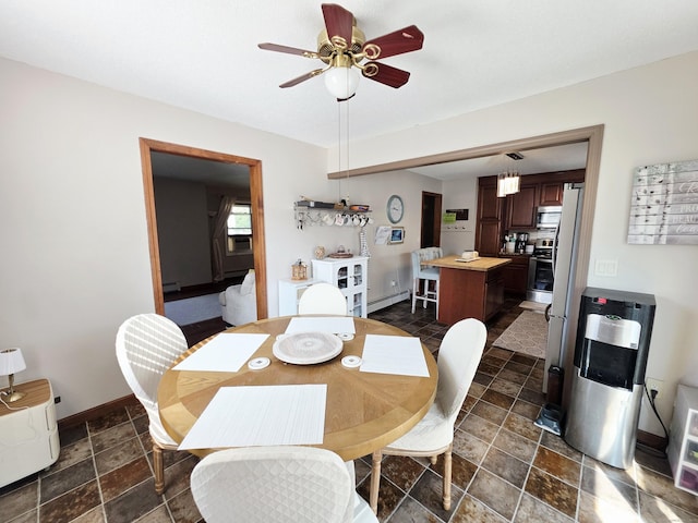 23 Teach St, Enfield, CT 06082 - dining space with dark stone finish flooring, a ceiling fan, and a baseboard radiator