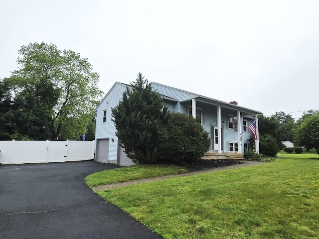 23 Teach St, Enfield, CT 06082 - view of front of home featuring a gate, a chimney, a garage, and asphalt driveway