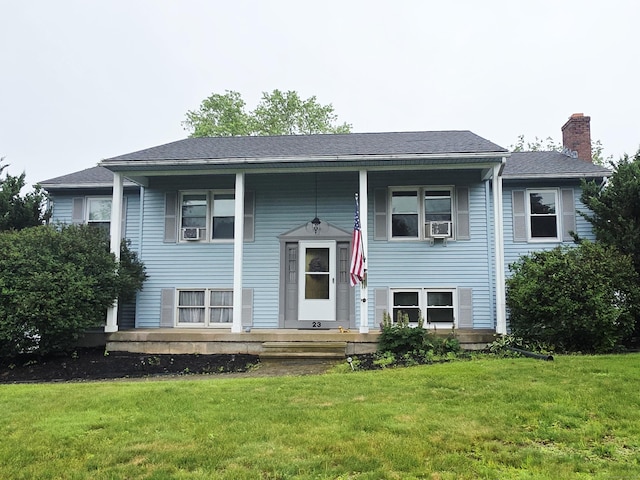23 Teach St, Enfield, CT 06082 - raised ranch featuring a porch, a chimney, and a front lawn