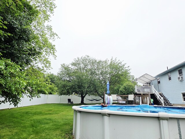 23 Teach St, Enfield, CT 06082 - view of swimming pool with stairs, a wooden deck, and a fenced backyard