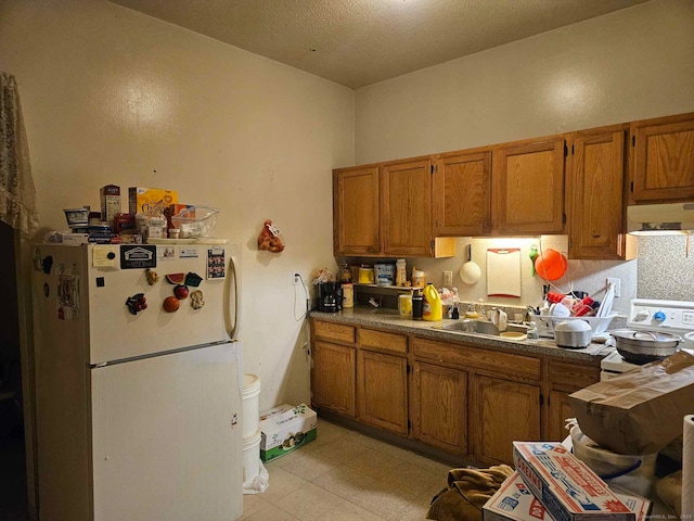 763 Park St, Hartford, CT 06106 - kitchen with freestanding refrigerator, stove, extractor fan, and brown cabinetry