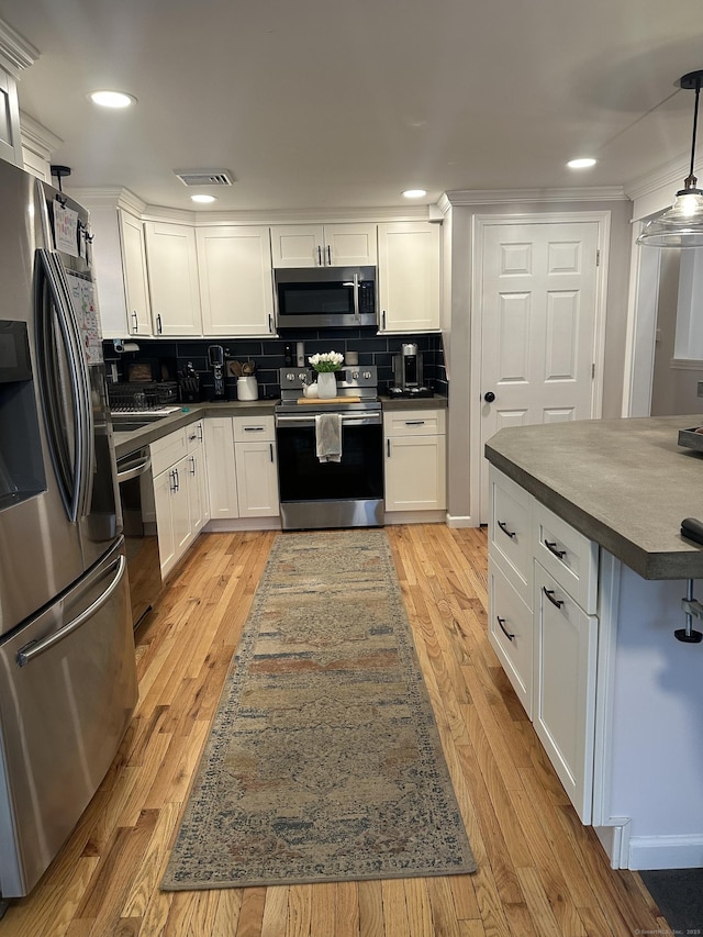 305 Rambler St, Bristol, CT 06010 - kitchen with stainless steel appliances, dark countertops, white cabinetry, decorative backsplash, and crown molding