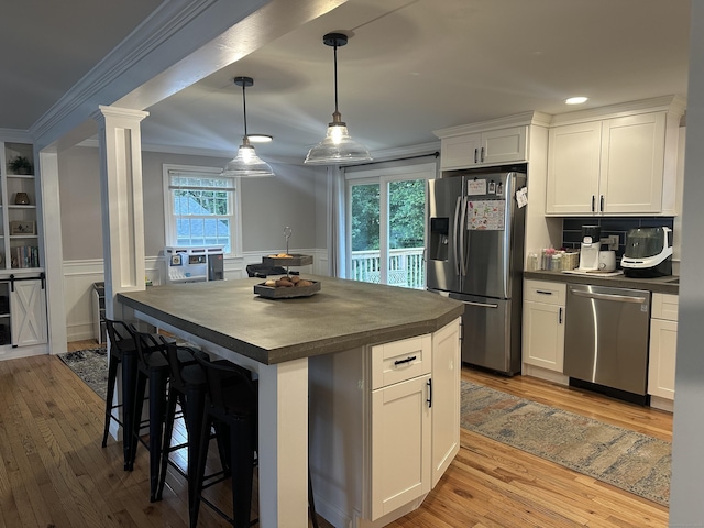 305 Rambler St, Bristol, CT 06010 - kitchen with stainless steel appliances, dark countertops, light wood-style floors, white cabinets, and plenty of natural light