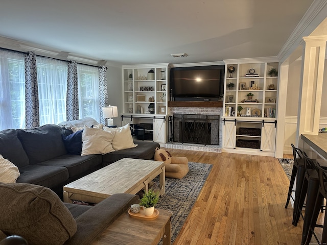 305 Rambler St, Bristol, CT 06010 - living room with a fireplace with raised hearth, light wood finished floors, and crown molding