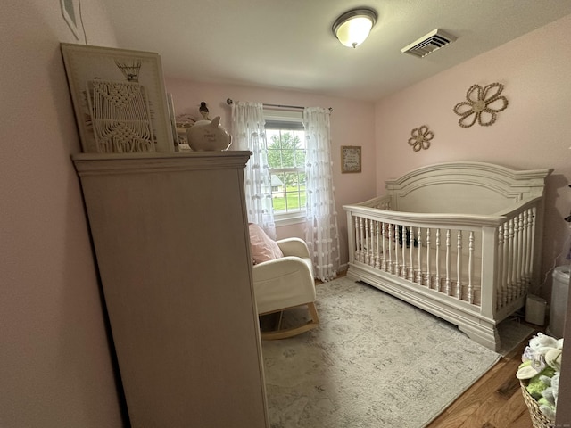 305 Rambler St, Bristol, CT 06010 - bedroom with wood finished floors and a nursery area