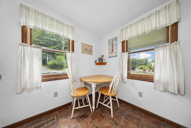136 Reynolds Bridge Rd, Thomaston, CT 06787 - dining room with healthy amount of natural light and dark stone finish floors