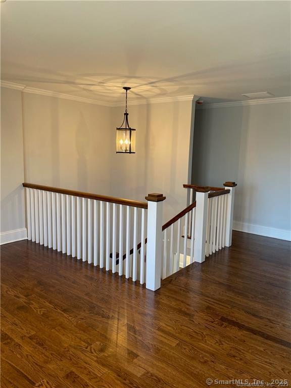 42 Long River Rd, Sherman, CT 06784 - hallway with an upstairs landing, wood finished floors, a chandelier, and crown molding