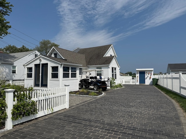 96 Chalker Beach Rd, Old Saybrook, CT 06475 - view of front of house with driveway and roof with shingles