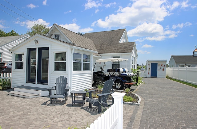 96 Chalker Beach Rd, Old Saybrook, CT 06475 - view of front of home featuring a shingled roof and an outbuilding