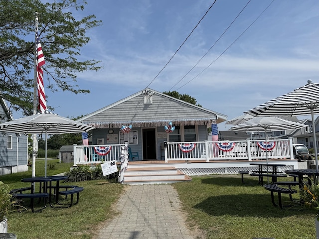 96 Chalker Beach Rd, Old Saybrook, CT 06475 - view of front of home with a front yard and a porch