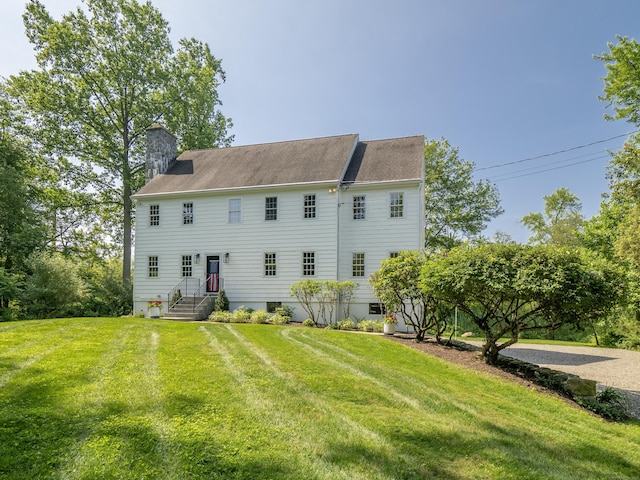 109 Westport Rd, Wilton, CT 06897 - back of house featuring a chimney and a yard