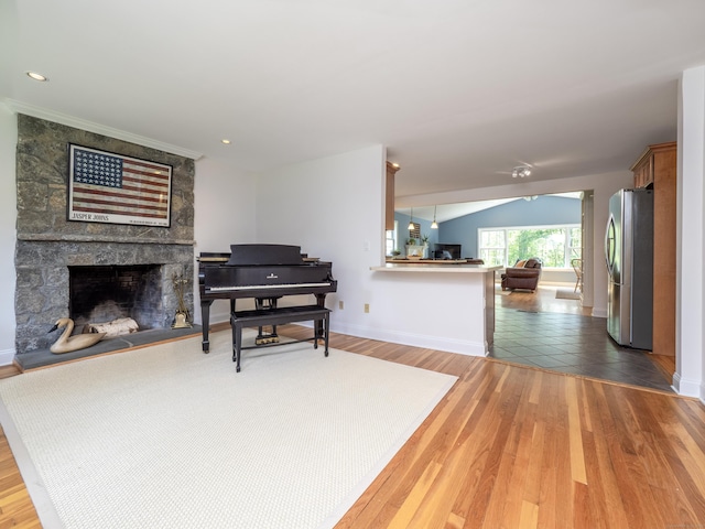109 Westport Rd, Wilton, CT 06897 - living room with a stone fireplace, wood finished floors, and lofted ceiling