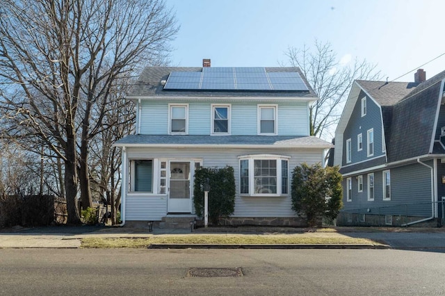 314 Judson Pl, Bridgeport, CT 06610 - american foursquare style home featuring entry steps, roof mounted solar panels, and a chimney