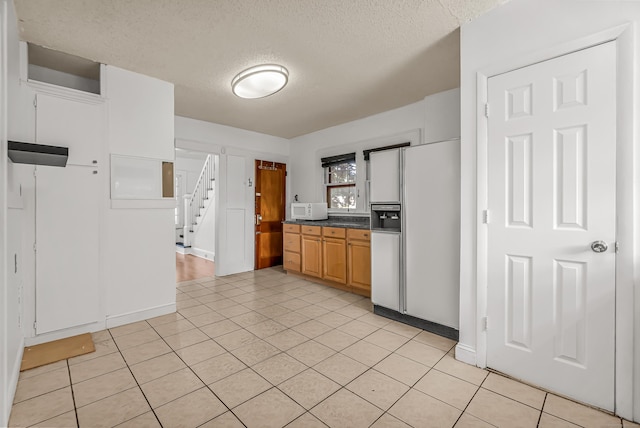314 Judson Pl, Bridgeport, CT 06610 - kitchen featuring white appliances, a textured ceiling, open shelves, dark countertops, and light tile patterned floors