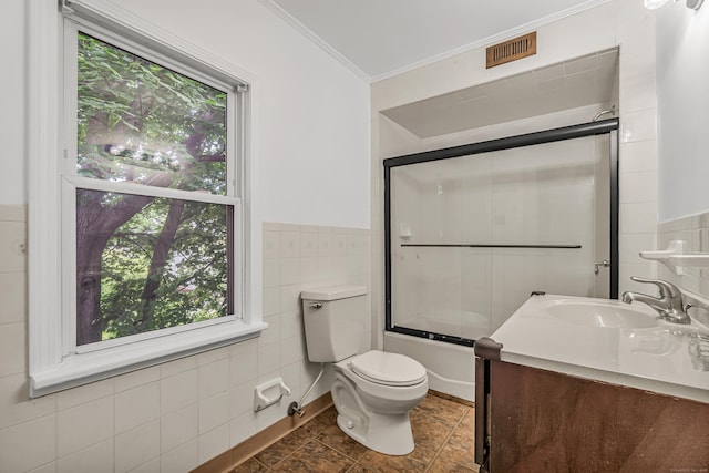 314 Judson Pl, Bridgeport, CT 06610 - bathroom with ornamental molding, vanity, enclosed tub / shower combo, plenty of natural light, and tile walls