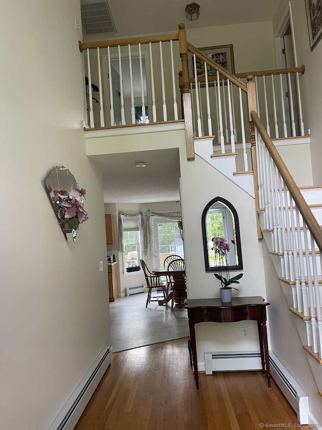 475 Niederwerfer Rd, South Windsor, CT 06074 - stairway featuring a baseboard radiator and wood finished floors