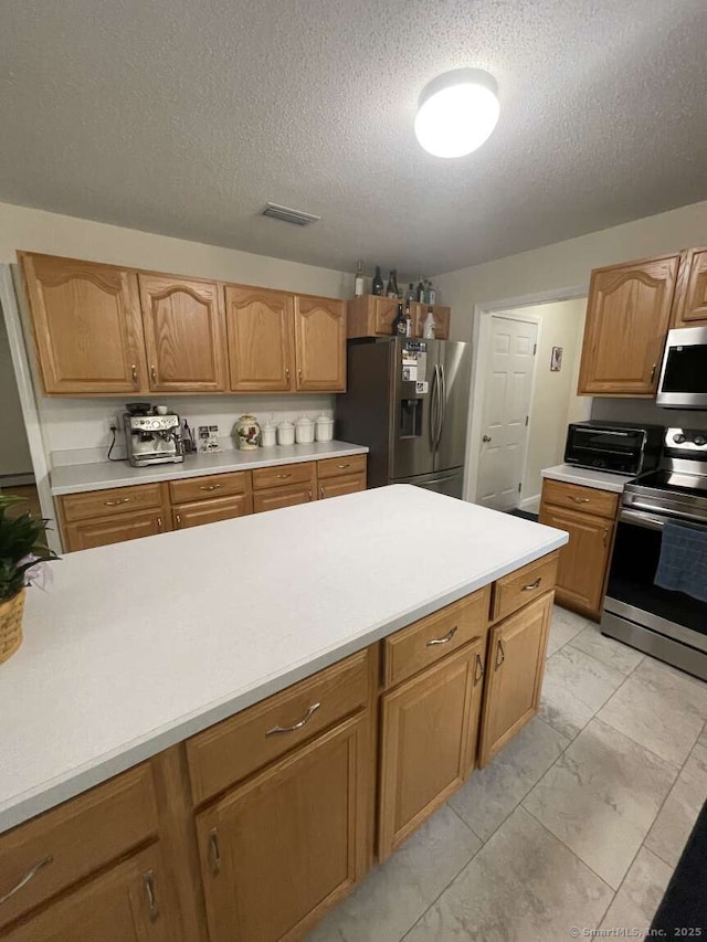 475 Niederwerfer Rd, South Windsor, CT 06074 - kitchen with stainless steel appliances, light marble finish floors, light countertops, a textured ceiling, and brown cabinets