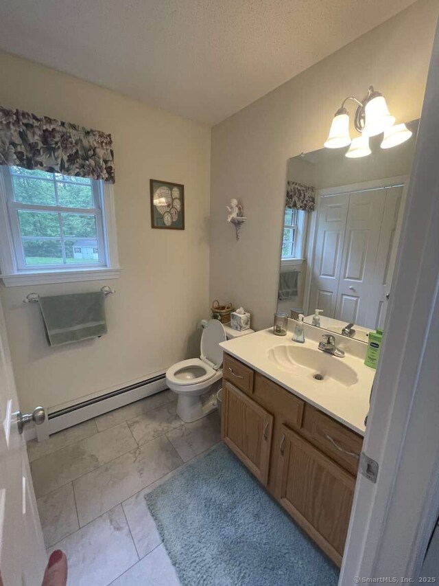475 Niederwerfer Rd, South Windsor, CT 06074 - bathroom with baseboard heating, vanity, marble look tiles, and a chandelier