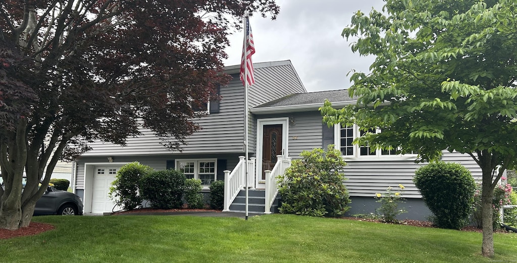 56 Dellwood Dr, Waterbury, CT 06708 - tri-level home featuring a garage and a front yard