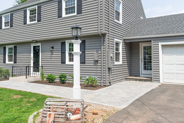 114 Boulter Rd, Wethersfield, CT 06109 - doorway to property featuring roof with shingles