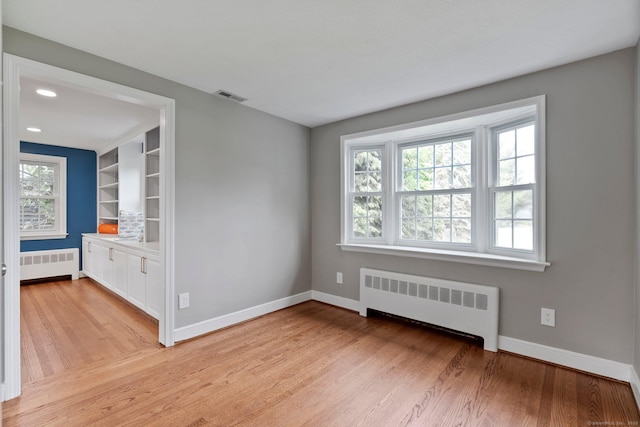 114 Boulter Rd, Wethersfield, CT 06109 - empty room with radiator, light wood-style flooring, and recessed lighting